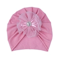 Close-up of pink baby turban hat featuring lace flower, ribbon bow and faux diamond - Dusty Rose Hat