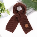 Close-up of dark brown knit scarf with vertical rib texture and leather logo patch - Brown