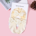 Detail of baby headband and socks set with textured bubble fabric bows in cream yellow - Off-white