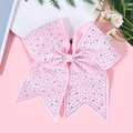 Macro detail of pink ribbon bow hair clip decorated with sparkling colorful rhinestones - Pink