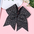 Detailed macro shot of a black bow hair clip featuring colorful sparkling rhinestones - Black