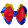 Detailed macro view of the layered red yellow and blue grosgrain ribbon bow accessory - Red & Blue
