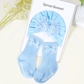 Detail of light blue cotton baby hat and socks set with lace bows and rib texture - Blue Bow