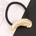 Detail of high-elastic black hair tie with gold feather charm and inset pearls - Gold