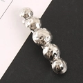 Minimalist silver ball-shaped metal hair clip with hammered texture on dual background - Silver