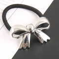 Fashionable ponytail hair tie with silver metallic wavy bow and black elastic cord - Silver