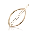 Macro detail of the golden hollow eye-shaped hair clip with reflective mirror finish - Gold