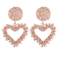 Close-up of rose gold heart drop earrings with intricate starburst textured surface - Rose Gold