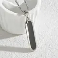Detailed close-up of a silver rectangular geometric pendant with black inlay on box chain - Beveled Steel