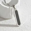 Macro detail of silver geometric pendant with black inlay on white textured background - Non-beveled Steel