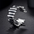 Close-up of a silver geometric ring with black enamel inlay and adjustable opening - US 6 / Black & White Jigsaw Geometric Style (R592)