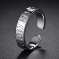 Detail of adjustable silver steel ring with relief texture and polished inner band - US 6 / Letter Abstract Texture Style (R601)