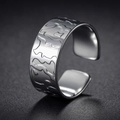 Detail of silver geometric wide ring with irregular embossed texture and open design - US 6 / Rock Relief Texture Style (R605)