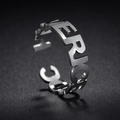 Macro shot of silver stainless steel ring with hollowed AMERICAN letters design - Hollow Letter Style (R602)