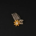 Detail shot of vintage flower hair comb with yellow rhinestones and center pearl - Yellow Rhinestone