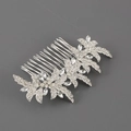 Detailed view of silver bridal hair comb with leaf patterns and sparkling rhinestones - White Zirconia Style
