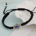 Detail of hand-woven black cord bracelet featuring a silver Hamsa Hand and blue Evil Eye charm - Black Hamsa Hand (BN-0149-7)