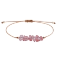 Handgefertigtes Armband mit rosa Natursteinen und Goldperlen an einer braunen Kordel - Wassermelonen Quarz