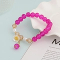 Detailed macro view of a beaded bracelet with pink crystals and a white flower charm - Pink (BNS-0290)