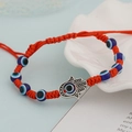 Red braided rope bracelet featuring blue evil eye beads and a silver Hamsa hand charm - Red Five Eyes Hamsa Hand (BN-0149-8)