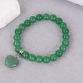 Close-up of 8mm green crystal beaded bracelet with a translucent heart-shaped stone pendant - Green Aventurine (BNS-0390)