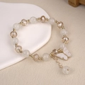 Close-up of beaded butterfly bracelet with white crystals and gold metal accents - 6.5cm Diameter / White Butterfly Bracelet Style 1