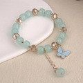 Detail of beaded bracelet with blue square beads, crystal charms, and butterfly pendant - 6.5cm Diameter / Light Blue Butterfly Bracelet Style 2