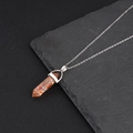 Hexagonal crystal pendant necklace with orange stone fragments and silver chain link - Orange