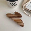 Detail of large wood-like hair claw clip next to pearls and coffee in an elegant scene - Ingot Shape