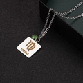 Silver Virgo zodiac pendant necklace featuring a green gemstone and engraved gold text - Virgo Zodiac Tag (NST-0118)