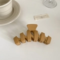Detailed view of large matte khaki geometric hair claw clip on minimalist white surface - Khaki