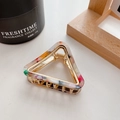 Golden triangular metal hair claw with floral acetate pattern in an elegant lifestyle setting - Starry Sky Color