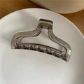 Macro detail of transparent grey acrylic hair claw clip with geometric hollow design - Smoke