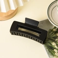 Close-up of matte black rectangular hair claw clip for thick hair with sleek hollow design - Rectangular Style Black