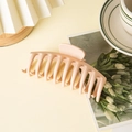 Matte warm peach shark hair claw clip for thick hair displayed on an elegant aesthetic table - Bone Style Creamy White