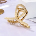 Detail of large acetate metal hair claw clip with marble texture on satin background - Beige