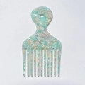 Macro detail of marble pattern acetate wide-tooth comb with handle hanging hole - Light Green