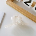 Close-up of butterfly acetate claw clip in creamy white with metallic gold spring - White