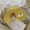 Lichtdurchlässige bernsteinfarbene Acetat-Haarklammer mit silbernem Metall-H-Logo - Hellgelb