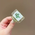 Close-up of a mini Mahjong tile hair clip featuring the Red One bird on green resin - One of Bamboos