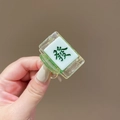 Detailed view of a green and white mahjong hair clip with the lucky character FA - Green Fortune (A-44-23 Fa Cai)