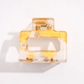 Close-up of amber patterned acrylic hair claw with gold gold-leaf accents and metal spring - Yellow