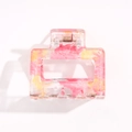 Pink marble texture acrylic hair claw clip with gold glitter details on white backdrop - Pink