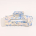 Macro detail of sky blue and white marbled acetate hair claw clip with cutout - Blue