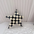 Detailed close-up of a star-shaped hair clip with black and white checkered acetate pattern - Black & White Checkerboard
