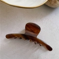 Detailed view of medium brown tortoiseshell claw clip with a glossy acetate finish - Amber (A9-1-13)