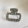 Detail view of large acetate hair claw clip with black and white patterns and silver metal teeth - Approx 6cm / Spotted Black Apricot