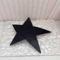 Glossy black star hair clip with checkerboard pattern on textured glass background - Black Shiny Surface