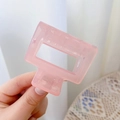 Detail of a translucent pink square hair claw clip with a strong metal spring mechanism - 5cm / Jelly Light Pink