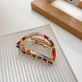 Detail of a semi-circular gold metal hair claw clip with colorful marble acetate patterns - Starry Sky Color